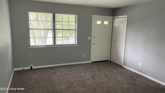323 Crossgate Rd, Elizabethtown, KY 42701 - foyer featuring dark colored carpet, baseboards, and a textured ceiling