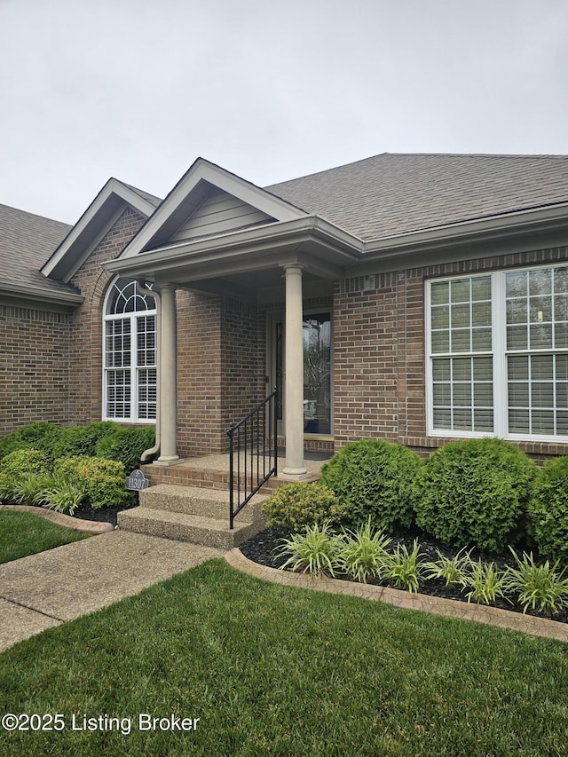 11307 Wind Haven Way, Louisville, KY 40291 - entrance to property featuring brick siding, roof with shingles, and a porch