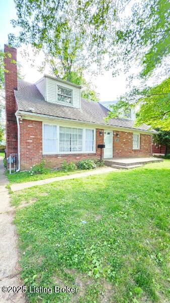 2228 Amboy Dr, Louisville, KY 40216 - view of front of property with brick siding, a front yard, a chimney, and a patio