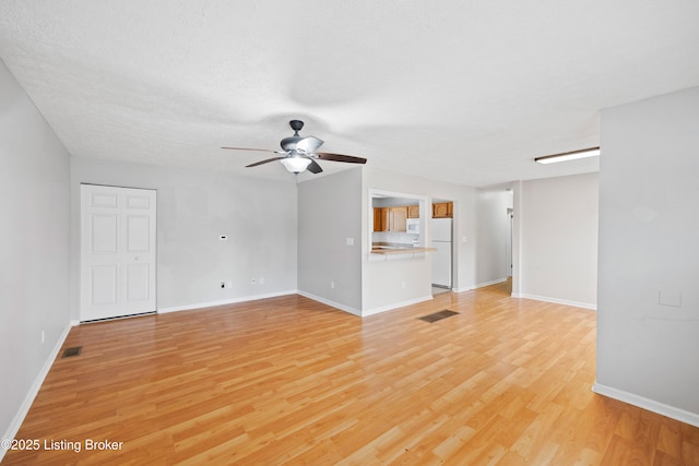 265 N Steedland Dr, Shepherdsville, KY 40229 - unfurnished living room with light wood finished floors, ceiling fan, and baseboards