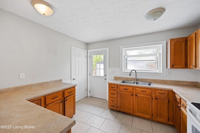265 N Steedland Dr, Shepherdsville, KY 40229 - kitchen with a sink, brown cabinetry, light tile patterned floors, light countertops, and a textured ceiling