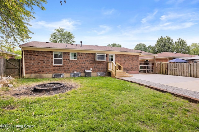 265 N Steedland Dr, Shepherdsville, KY 40229 - rear view of property featuring brick siding, a patio area, an outdoor fire pit, and a gate