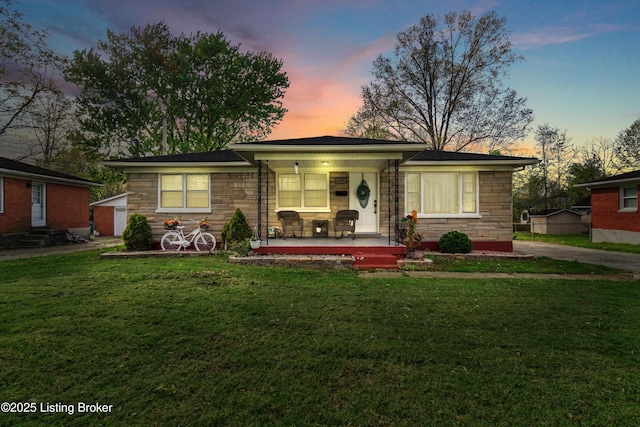 4328 Dohn Ave, Louisville, KY 40216 - view of front of house featuring stone siding, a porch, and a yard