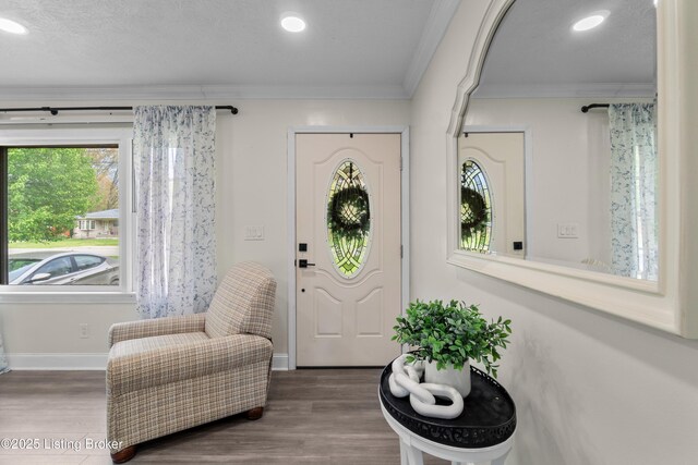 4328 Dohn Ave, Louisville, KY 40216 - entrance foyer with wood finished floors, plenty of natural light, ornamental molding, baseboards, and recessed lighting