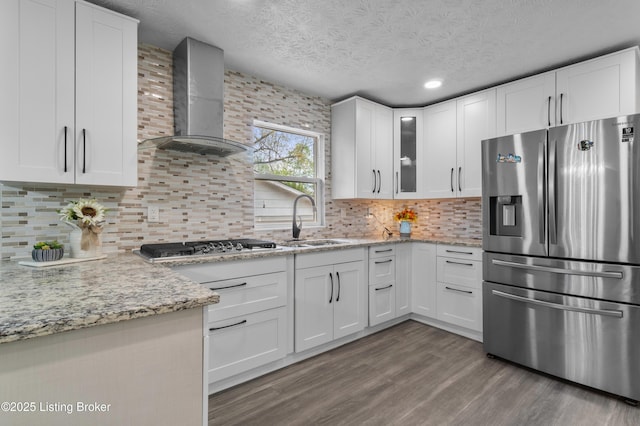 4328 Dohn Ave, Louisville, KY 40216 - kitchen featuring appliances with stainless steel finishes, wall chimney exhaust hood, a sink, dark wood-style flooring, and white cabinetry