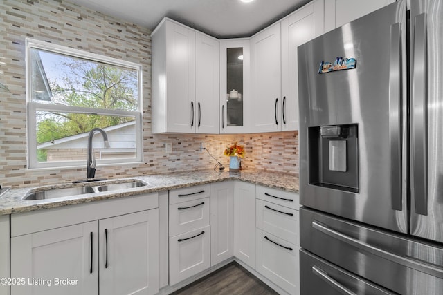 4328 Dohn Ave, Louisville, KY 40216 - kitchen with stainless steel fridge, a sink, white cabinets, and glass insert cabinets
