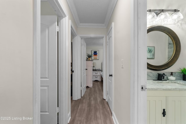 4328 Dohn Ave, Louisville, KY 40216 - hallway with crown molding, wood finished floors, a sink, and baseboards