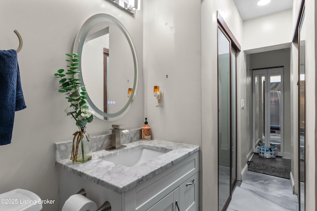 4328 Dohn Ave, Louisville, KY 40216 - bathroom with vanity, marble look tiles, and toilet