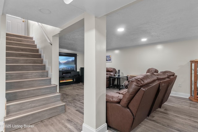 4328 Dohn Ave, Louisville, KY 40216 - living room with wood finished floors, a textured ceiling, baseboards, stairs, and recessed lighting