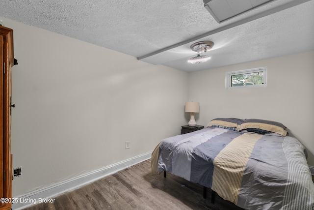 4328 Dohn Ave, Louisville, KY 40216 - bedroom with wood finished floors, a textured ceiling, and baseboards