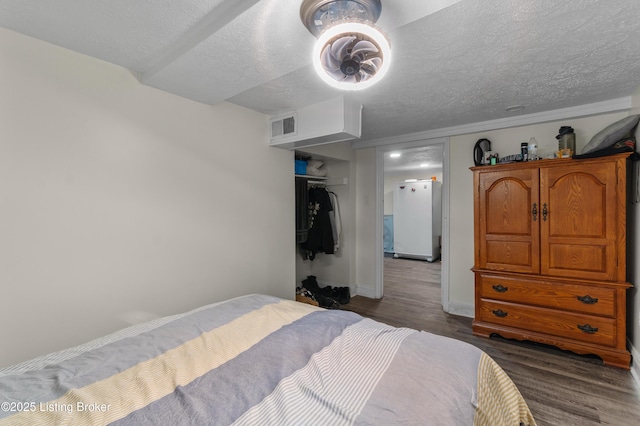 4328 Dohn Ave, Louisville, KY 40216 - bedroom with wood finished floors, a textured ceiling, and baseboards