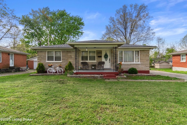 4328 Dohn Ave, Louisville, KY 40216 - view of front of home with stone siding, covered porch, and a front lawn