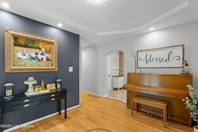 11805 Cedardale Rd, Anchorage, KY 40223 - sitting room with arched walkways, recessed lighting, light wood-type flooring, a tray ceiling, and baseboards