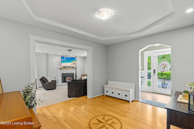 11805 Cedardale Rd, Anchorage, KY 40223 - living room featuring wood finished floors, a fireplace, a tray ceiling, and recessed lighting