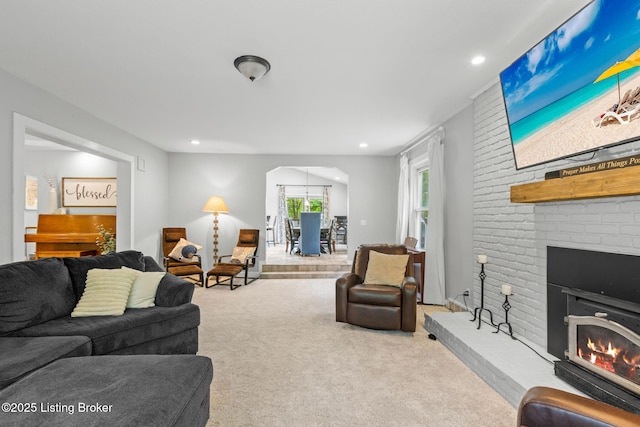 11805 Cedardale Rd, Anchorage, KY 40223 - carpeted living room featuring a brick fireplace, arched walkways, and recessed lighting