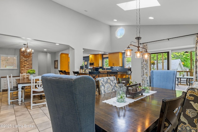 11805 Cedardale Rd, Anchorage, KY 40223 - dining space featuring high vaulted ceiling, a skylight, light tile patterned flooring, recessed lighting, and a chandelier