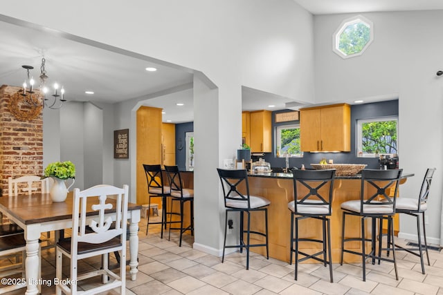 11805 Cedardale Rd, Anchorage, KY 40223 - kitchen with healthy amount of natural light, dark countertops, light tile patterned floors, recessed lighting, and a chandelier