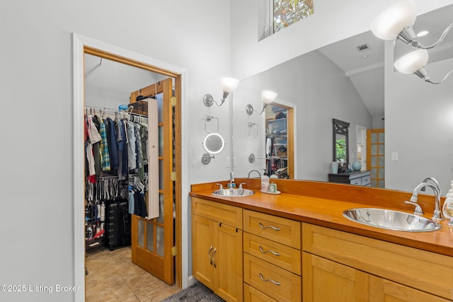 11805 Cedardale Rd, Anchorage, KY 40223 - bathroom with double vanity, a walk in closet, tile patterned floors, and lofted ceiling