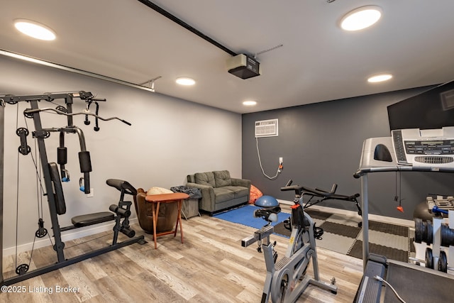 11805 Cedardale Rd, Anchorage, KY 40223 - workout room with wood finished floors, baseboards, a wall mounted air conditioner, recessed lighting, and a garage
