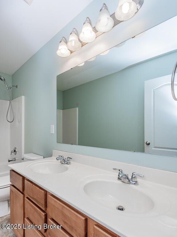 9006 Big Boulder Dr, Louisville, KY 40291 - full bathroom featuring toilet, double vanity, and bathtub / shower combination