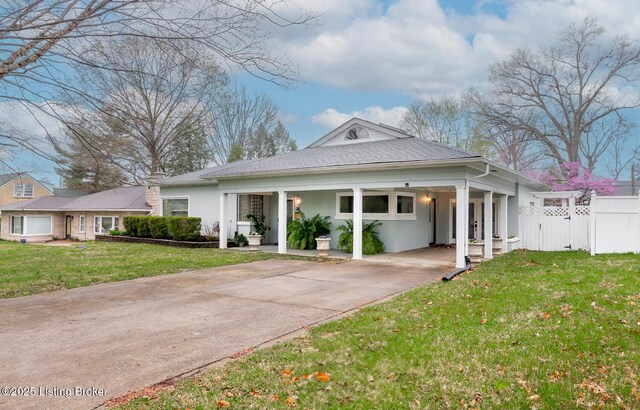 1031 Thruston Ave, Louisville, KY 40217 - view of front of house featuring driveway, stucco siding, a carport, and a shingled roof