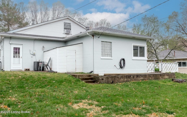 1031 Thruston Ave, Louisville, KY 40217 - rear view of property with a shingled roof, a lawn, and concrete block siding