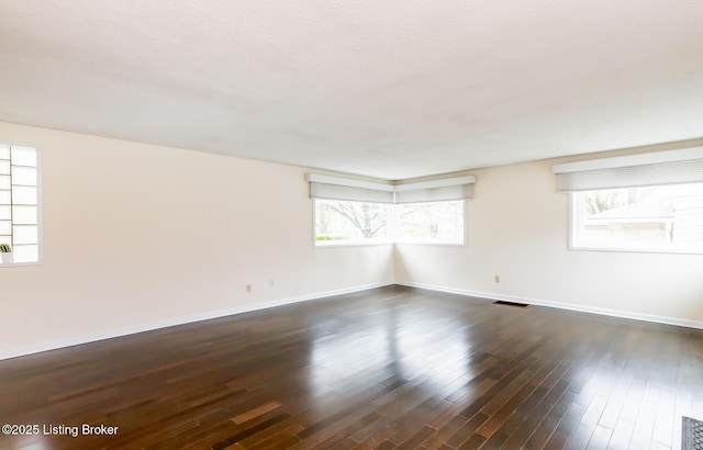 1031 Thruston Ave, Louisville, KY 40217 - empty room featuring plenty of natural light, baseboards, and dark wood finished floors