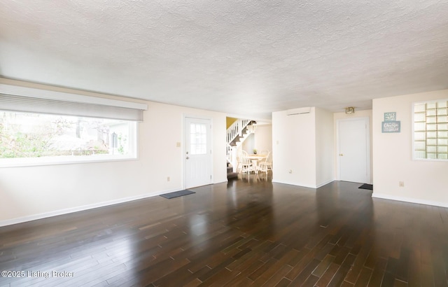 1031 Thruston Ave, Louisville, KY 40217 - unfurnished living room with stairs, baseboards, wood finished floors, and a textured ceiling