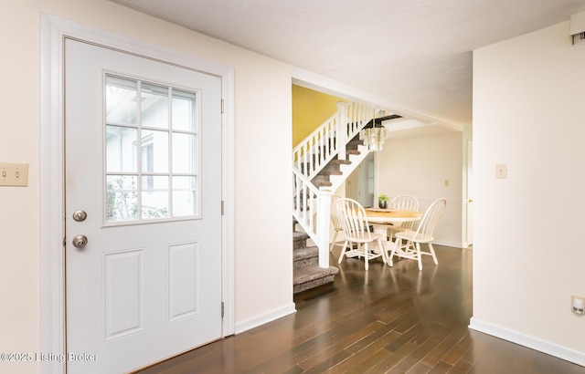 1031 Thruston Ave, Louisville, KY 40217 - entrance foyer featuring stairway, dark wood-type flooring, and baseboards