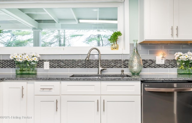1031 Thruston Ave, Louisville, KY 40217 - kitchen with stainless steel dishwasher, a sink, white cabinetry, decorative backsplash, and dark stone counters