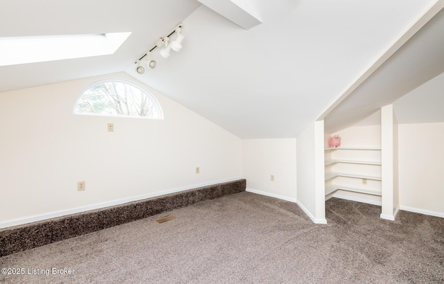 1031 Thruston Ave, Louisville, KY 40217 - additional living space featuring carpet flooring, vaulted ceiling, a skylight, and baseboards