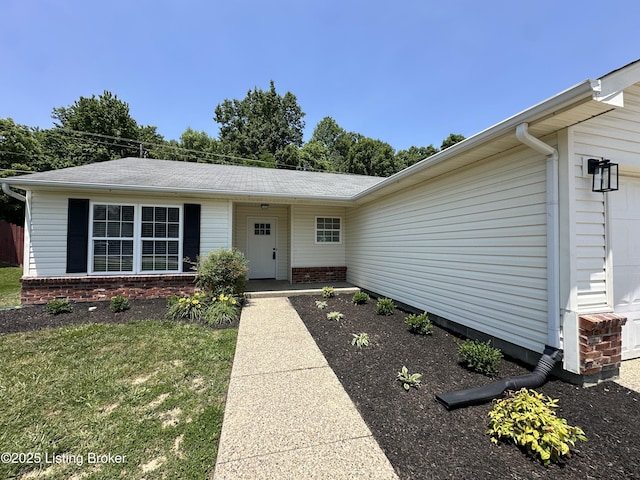 1129 Willow Oak Ln, La Grange, KY 40031 - view of exterior entry featuring an attached garage, a yard, and brick siding