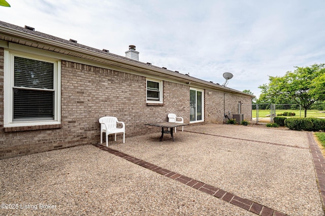 171 Williams Ct, Brooks, KY 40109 - rear view of house featuring brick siding, a gate, central AC unit, a patio area, and a chimney