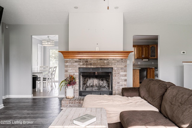 171 Williams Ct, Brooks, KY 40109 - living area with baseboards, wood finished floors, a fireplace, a chandelier, and a textured ceiling