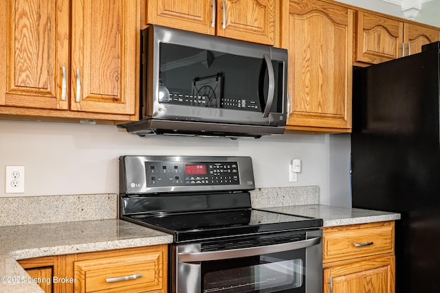 171 Williams Ct, Brooks, KY 40109 - kitchen with electric range, freestanding refrigerator, and brown cabinets