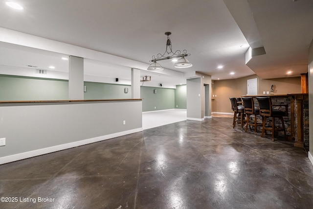 171 Williams Ct, Brooks, KY 40109 - unfurnished living room with baseboards, bar with sink, recessed lighting, and concrete floors