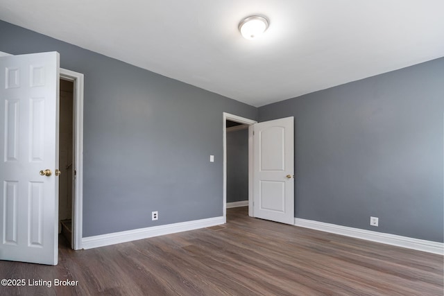 1119 Carlisle Ave, Louisville, KY 40215 - unfurnished bedroom with wood finished floors and baseboards