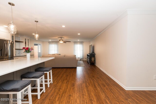 2401 Branning Rd, Thornhill, KY 40222 - kitchen featuring stainless steel fridge, white cabinetry, a breakfast bar, dark wood-type flooring, and hanging light fixtures