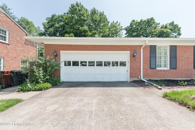 2401 Branning Rd, Thornhill, KY 40222 - view of front of house with asphalt driveway, brick siding, and a garage