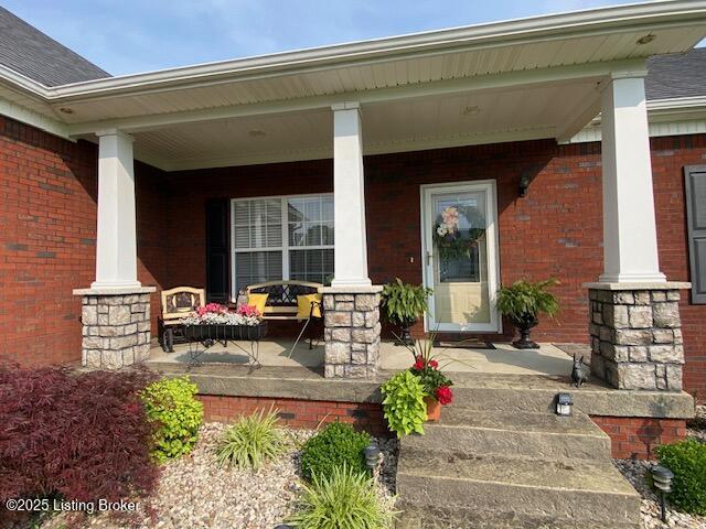 1013 Mallards Cv, Bardstown, KY 40004 - property entrance with a porch, brick siding, and roof with shingles