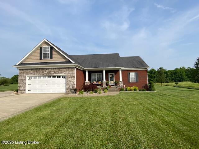 1013 Mallards Cv, Bardstown, KY 40004 - view of front facade with concrete driveway, covered porch, a front lawn, and a garage