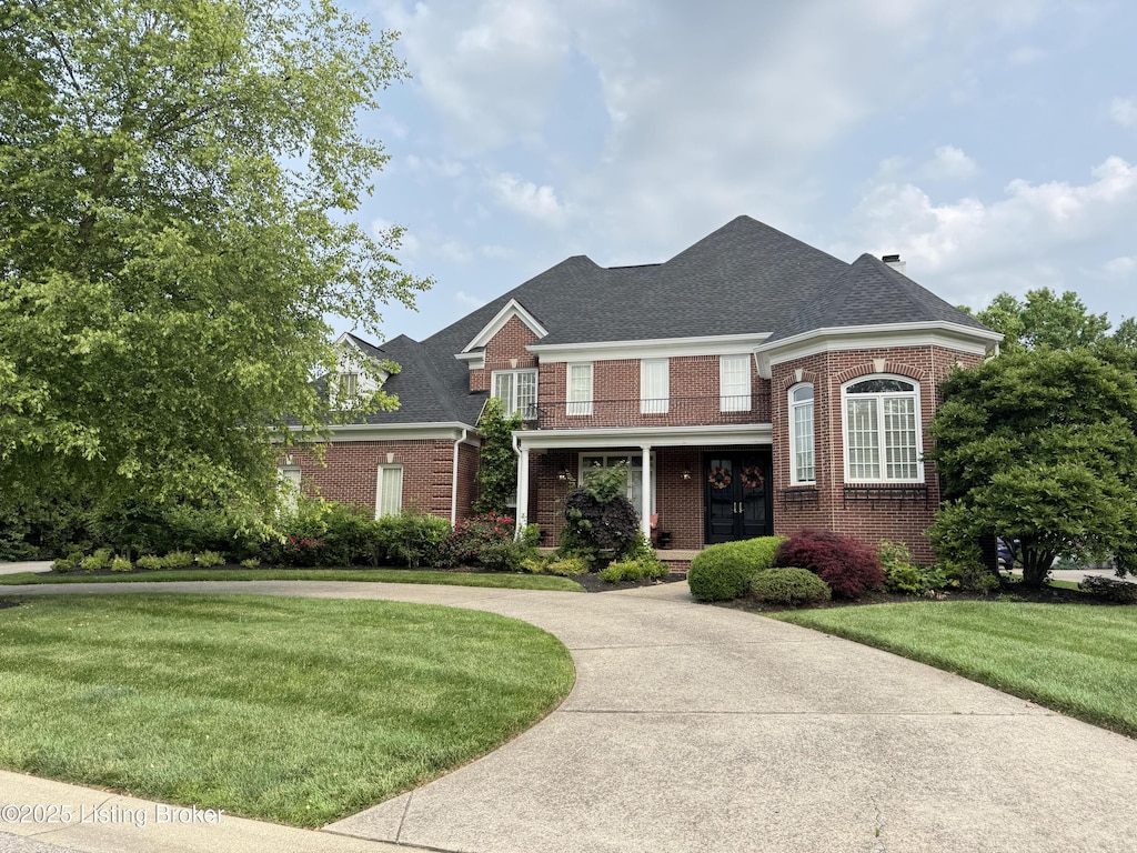 7902 Innisbrook Ct, Prospect, KY 40059 - view of front facade featuring brick siding, a front yard, a shingled roof, and curved driveway