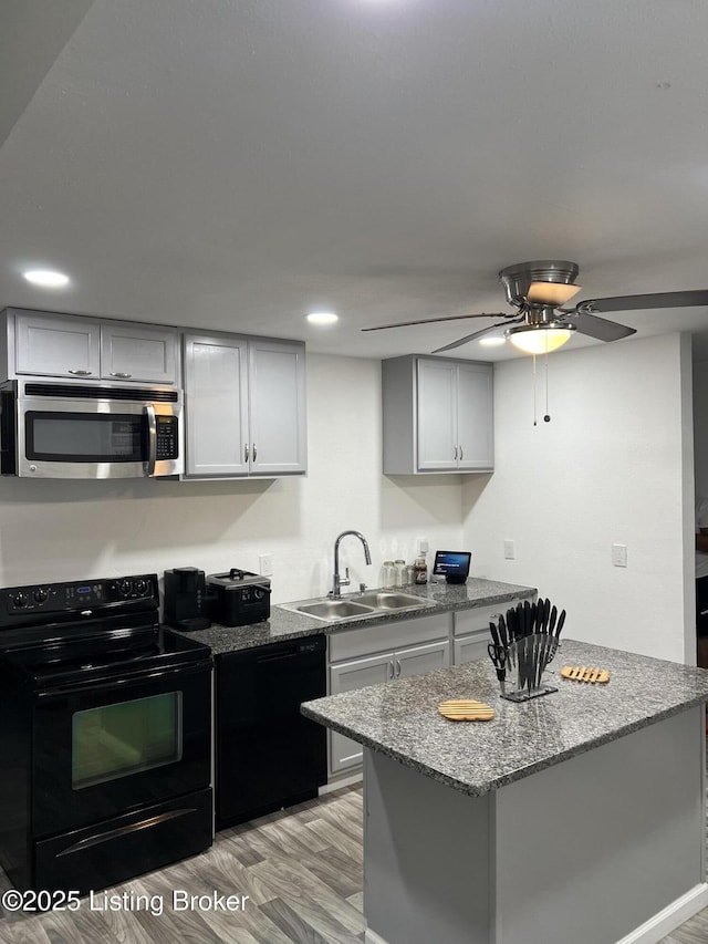3229 Hale Ave, Louisville, KY 40211 - kitchen with black appliances, a sink, light wood-style flooring, light stone countertops, and recessed lighting