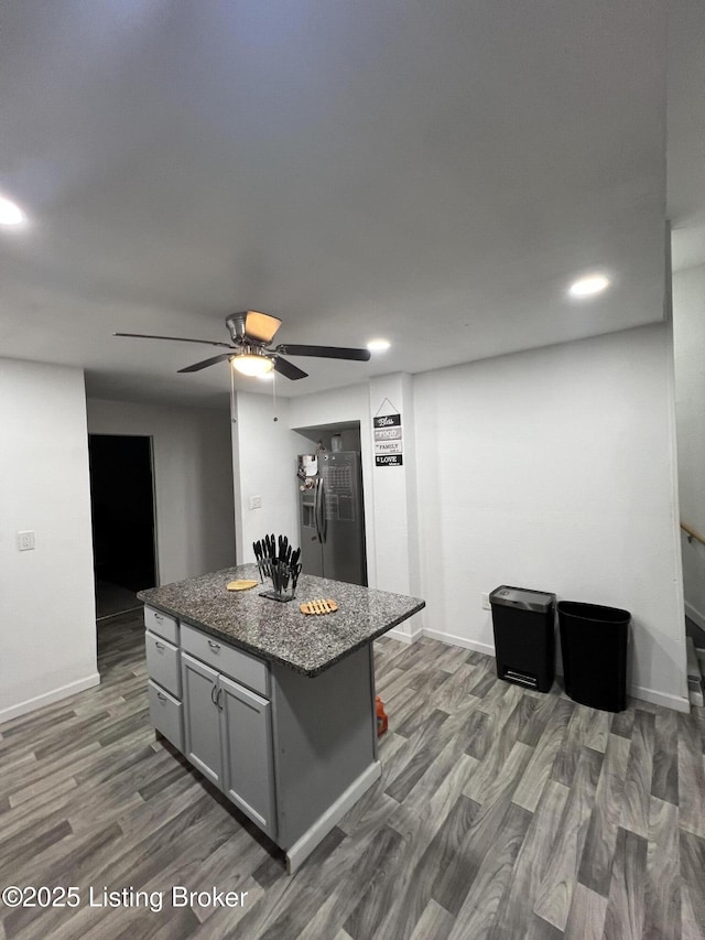 3229 Hale Ave, Louisville, KY 40211 - kitchen with stainless steel fridge with ice dispenser, gray cabinetry, a kitchen island, dark wood-style flooring, and recessed lighting