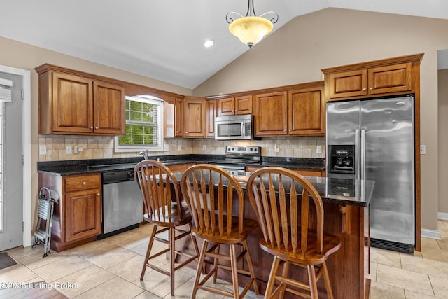 90 Chancellor Ct, Elizabethtown, KY 42701 - kitchen featuring appliances with stainless steel finishes, lofted ceiling, brown cabinets, a center island, and backsplash