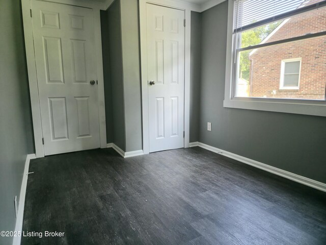 7125 Sky Blue Ave, Louisville, KY 40258 - unfurnished bedroom with dark wood-type flooring, baseboards, and a closet