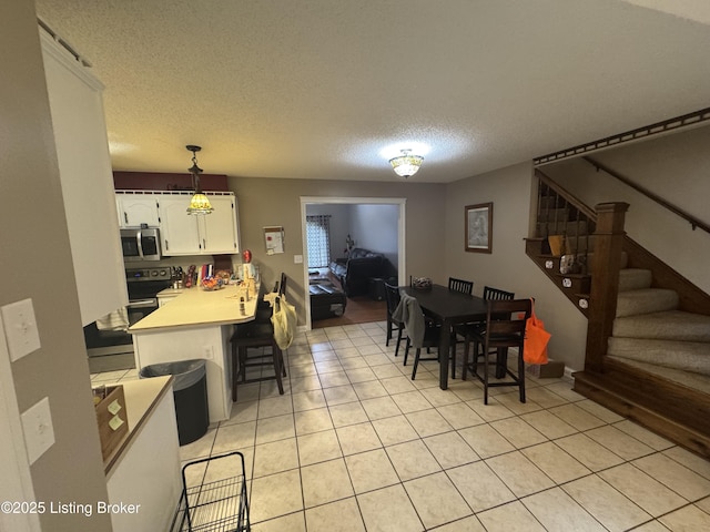1103 Foxfire Rd, Bardstown, KY 40004 - dining area with a textured ceiling, light tile patterned floors, and stairway