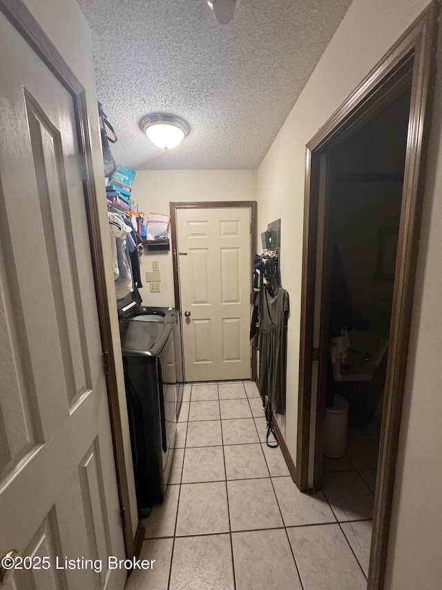 1103 Foxfire Rd, Bardstown, KY 40004 - laundry room with washing machine and dryer, light tile patterned floors, and a textured ceiling