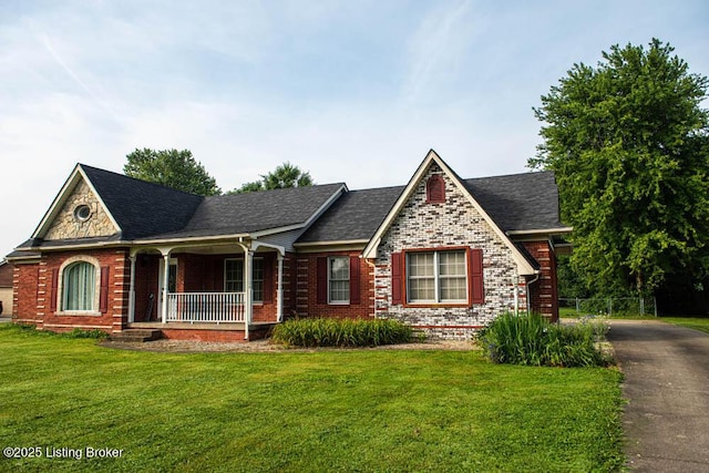 1103 Foxfire Rd, Bardstown, KY 40004 - tudor house featuring a porch, a front lawn, brick siding, driveway, and a shingled roof