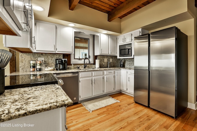1416 Taylor Wood Rd, Simpsonville, KY 40067 - kitchen featuring appliances with stainless steel finishes, decorative backsplash, a wooden ceiling with exposed beams, light wood-type flooring, and light stone countertops